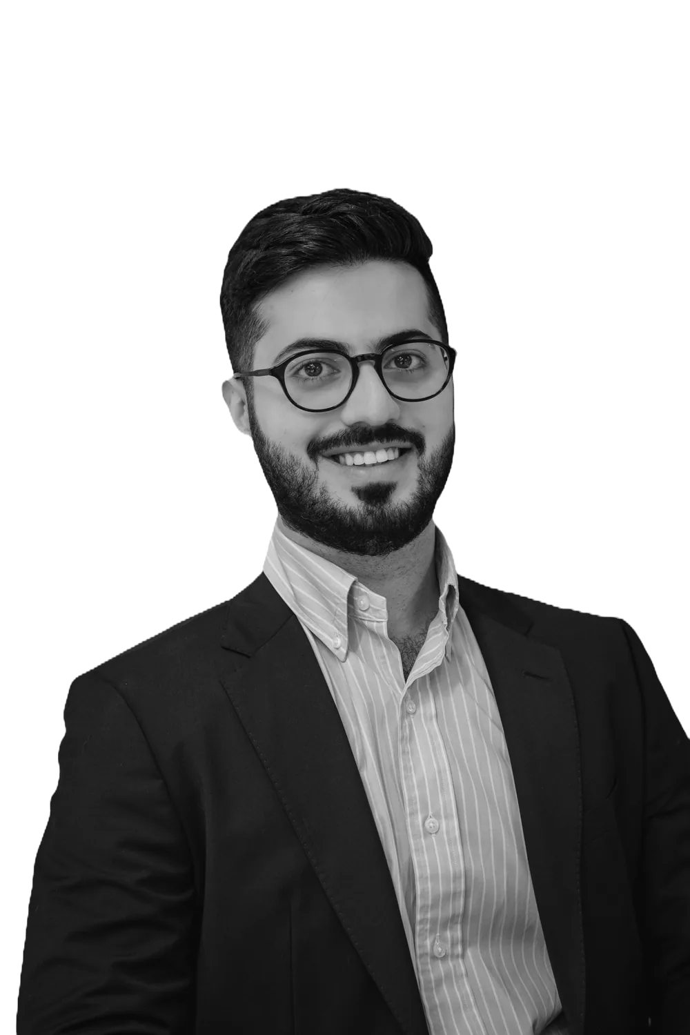 Black and white portrait of Abdullah Homsi smiling, wearing glasses and a dark blazer